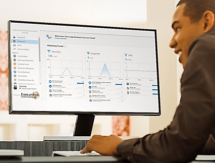 Man checking the reports and graphs of business on monitor Man checking the reports and graphs of business on monitor